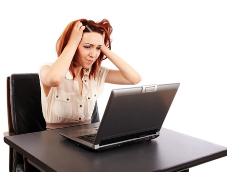 Stressed caucasian redhead woman at her computerの写真素材