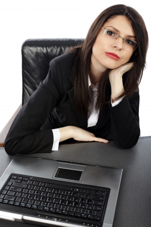 Closeup of pensive businesswoman with laptop, isolated on white backgroundの写真素材