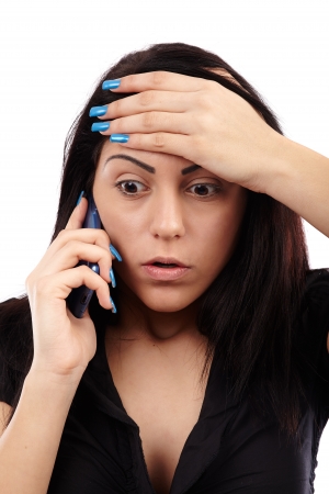 Shocked woman talking on the phone, closeup pose, isolated over white backgroundの写真素材
