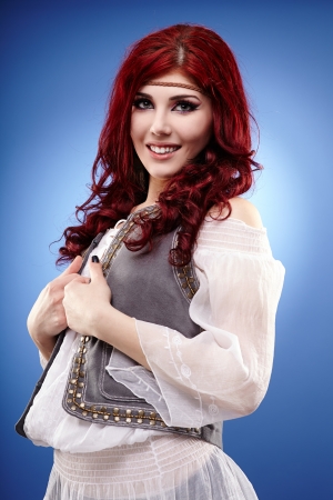 Beautiful hippie girl in glamour closeup, over blue backgroundの写真素材