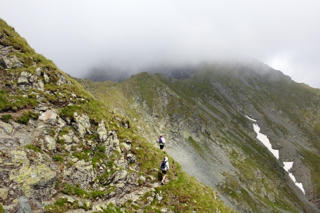 Teenage boy and his mother hiking into the Romanian Carpathians mountainsの写真素材