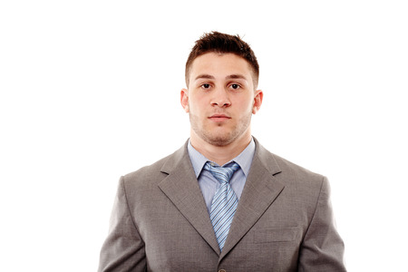 Portrait of young , handsome, confident businessman with a serious attitude, isolated on white backgroundの写真素材