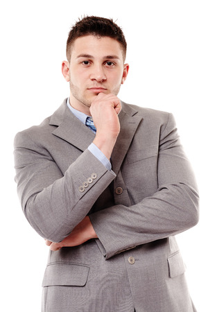 Portrait of pensive businessman with hand on chin, isolated over white backgroundの写真素材