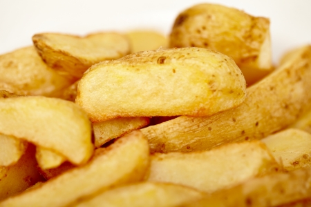 Closeup of wedges potatoes isolated on white background, selective focusの写真素材