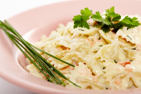 Farfalle pasta with smoked salmon and cheese sauceの写真素材