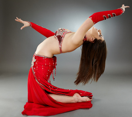 Beautiful ethnic bellydancer performing oriental dance in traditional costumeの写真素材