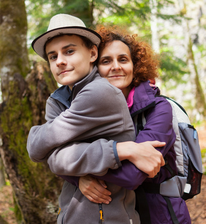 Happy mother and her son outdoors on a hikeの写真素材