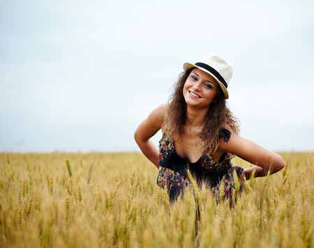 A happy caucasian young and beautiful woman in a wheat fieldの写真素材