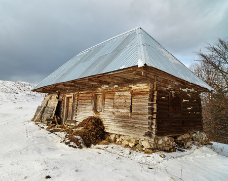 Old wooden barn in the countryside, in the winterの写真素材