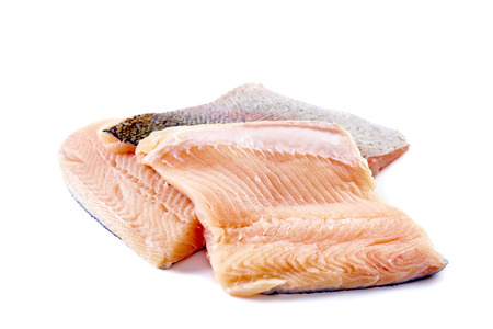 Uncooked trout filletes isolated on white backgroundの写真素材