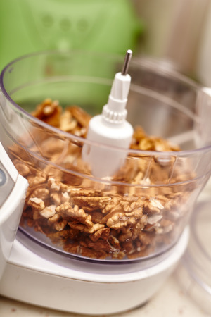 Kernel walnuts in a food processor ready to be crushed for prepare dessert