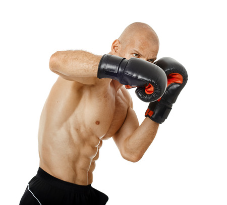 Muscular kickbox or muay thai fighter punching, isolated on white background
