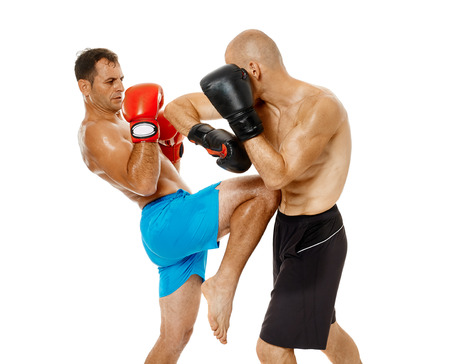 Two kickbox fighters sparring, full length isolated on white backgroundの写真素材