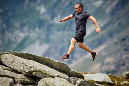Caucasian athlete trail running in the mountains, ultramarathonの写真素材