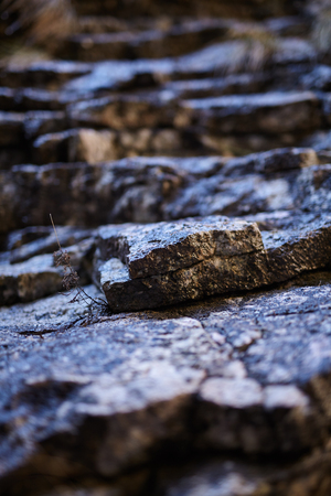 Closeup of a sedimentary mountain limestone rocks, with selective focus