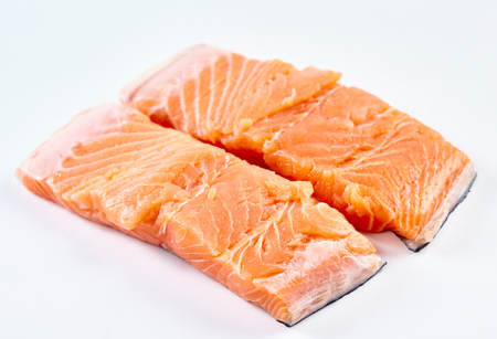 Closeup of raw salmon fillets on white backgroundの写真素材