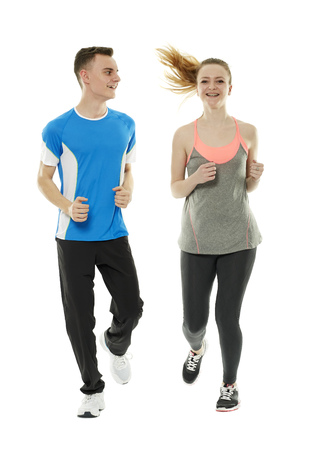 Couple of teenagers running isolated on white backgroundの写真素材