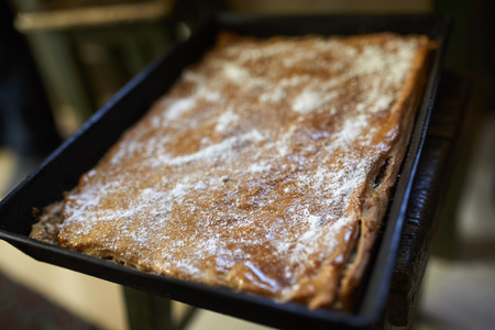Closeup of a tray with a homemade apple pie powdered with sugarの写真素材