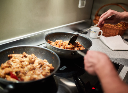 Man cooking at home alone a thai recipe in wok pansの写真素材