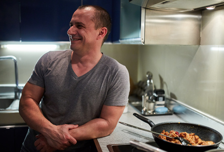 Man cooking at home alone a thai recipe in wok pansの写真素材