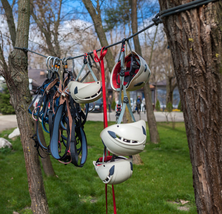 Harnesses, helmets and protective gear for climbers, outdoors