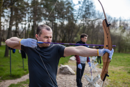 Man shooting with his bow at an outdoor rangeの写真素材