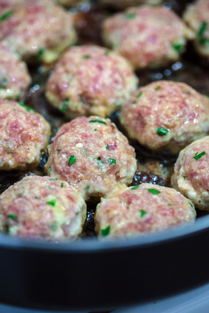 Turkey meatballs cooking in olive oil in a frying panの写真素材