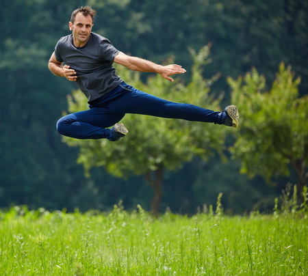 Kickbox fighter training outdoor near the forest