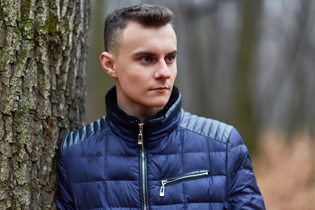 Trendy and handsome teenage boy in the parkの写真素材