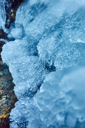 Beautifully shaped icicles on a mountain from a frozen waterfallの写真素材