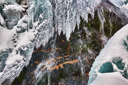 Frozen waterfall in winter time in the mountainsの写真素材