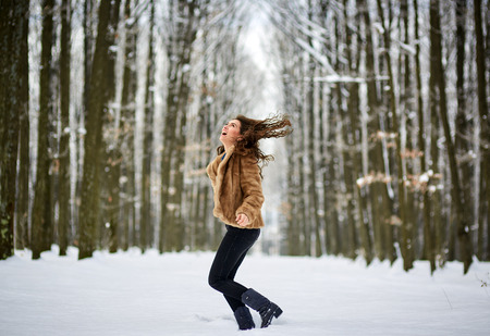 Full length of an attractive young woman in snow outdoorの写真素材