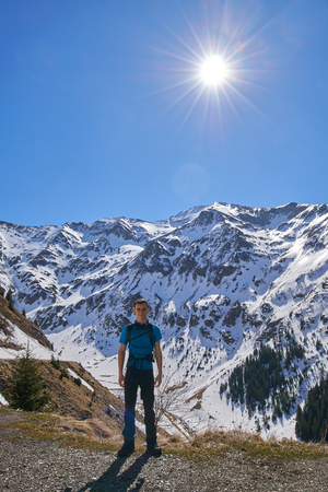 Teenage boy hiking in the rocky mountains at springtimeの写真素材