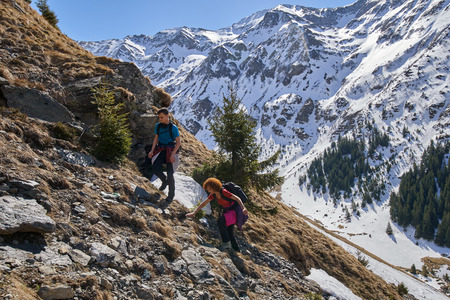Family hiking into the rocky mountains at springtimeの写真素材