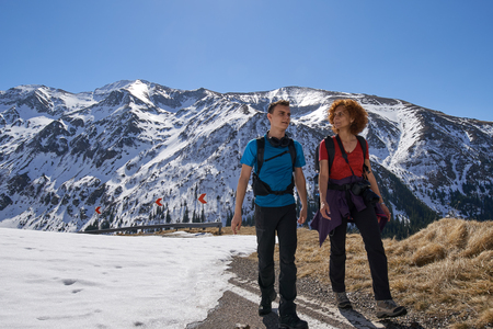 Family hiking into the rocky mountains at springtimeの写真素材