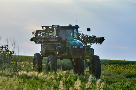 Big tractor with huge ground clearance used for spraying pesticides on fields