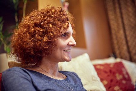 Closeup of a middle aged redhead woman indoorの写真素材