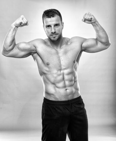 Fitness model portrait on gray background, studio shotの写真素材