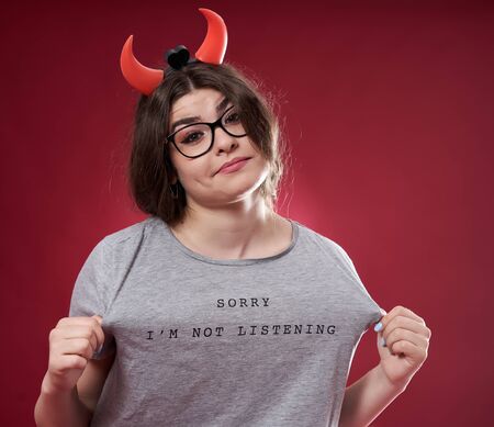 Portrait of a rebel young lady on red background
