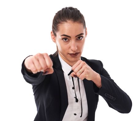 Young businesswoman punching to get ahead in competitive environmentの写真素材