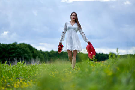 Gorgeous beauty model in summer dress posing outdoor in an oak forestの写真素材