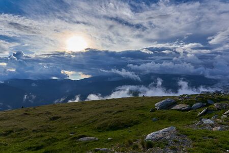 Summer landscape with high mountains and clouds in a summer dayの写真素材