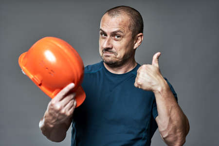 Engineer checking the quality of his new hardhatの写真素材