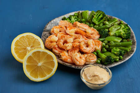 Delicious red king prawns prepared at wok on blue backgroundの写真素材