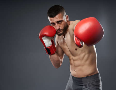 MMA fighter training, studio shot isolated on gray backgroundの写真素材