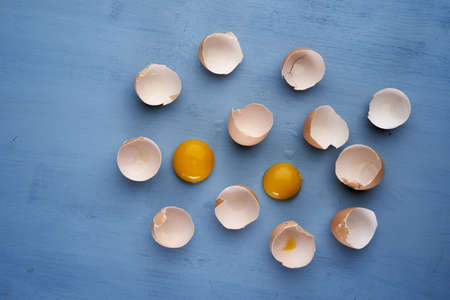 Broken egg shells on blue backgroundの写真素材