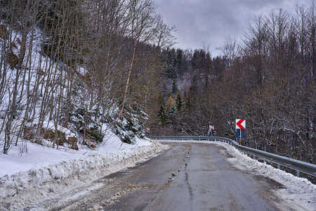 Empty road in the mountains during winter timeの写真素材
