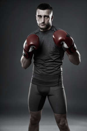 MMA fighter training, studio shot isolated on gray backgroundの写真素材