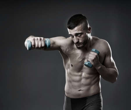 MMA fighter training, studio shot isolated on gray backgroundの写真素材