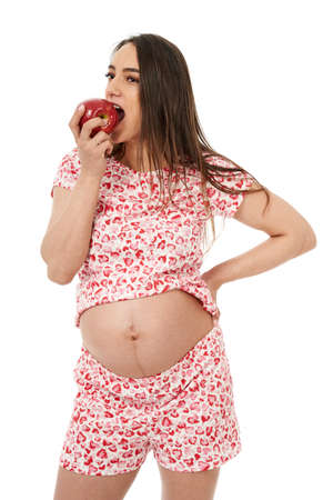 Pregnant woman with a juicy red apple, having cravingsの写真素材